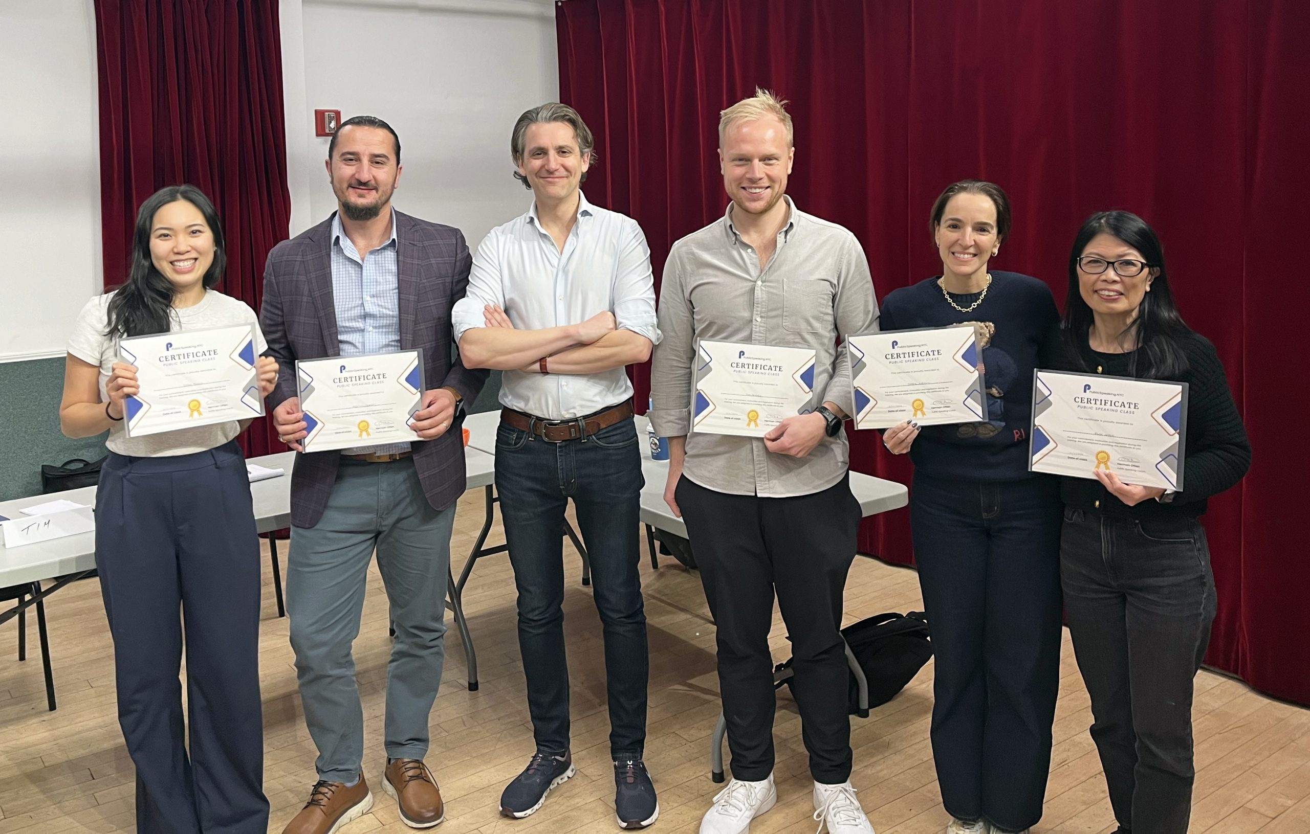 Participants receiving their certificate af the end of the public speaking class