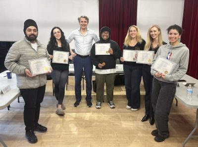 Participants at the end of the full-day public speaking class receiving their certificate.