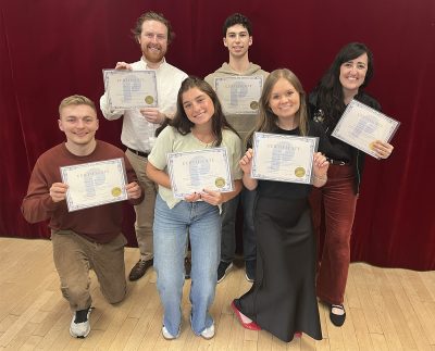 The group of participants posing for the photo and showing their certificate of participation. 