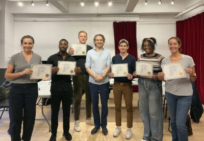 The group of participants at the end of the public speaking class posing with their certificates.