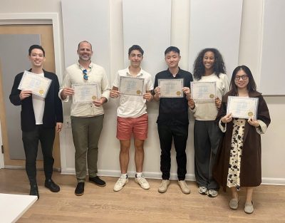 The participants of Herman's public speaking class holding their certificates. 